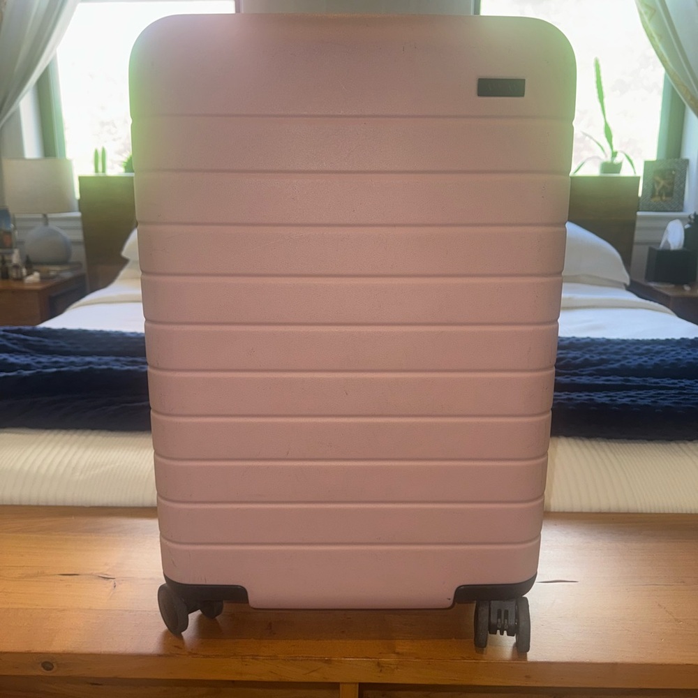 Away Bigger Carry On Rolling Suitcase in Pink